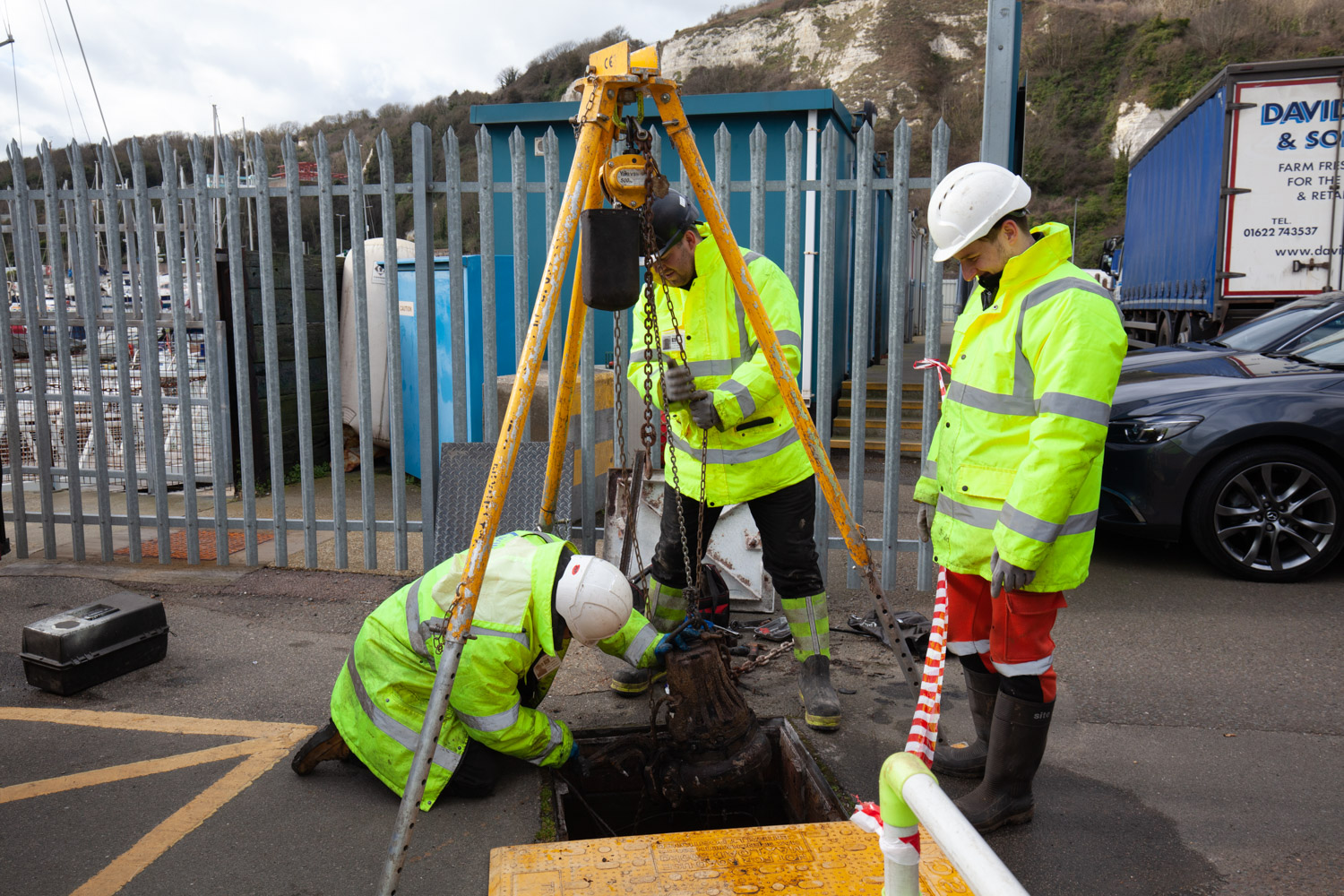 3 Willow engineers lifting a sewage pump to service it
